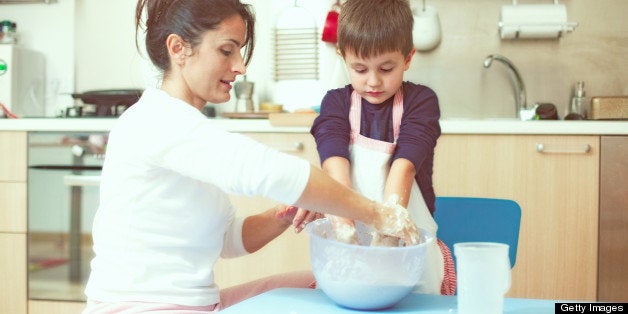 Mother and son cooking in their kitchen