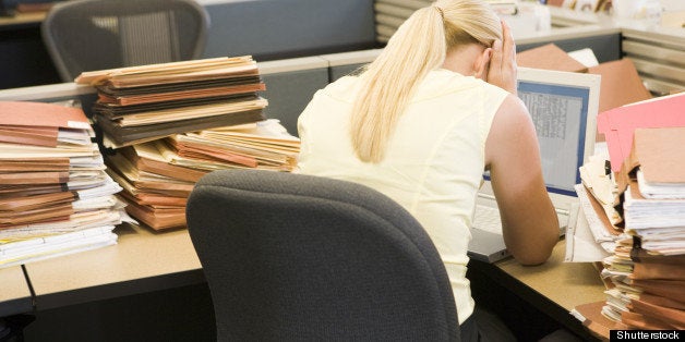 businesswoman in cubicle with...