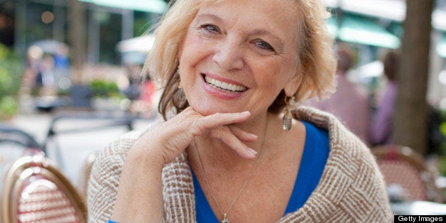 senior woman at sidewalk cafᅢᄅ, smiling