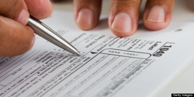 Close up of hands filling in tax form