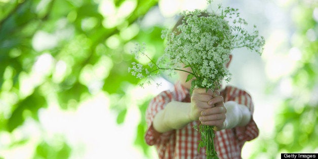 Boy offering bouquet of flowers