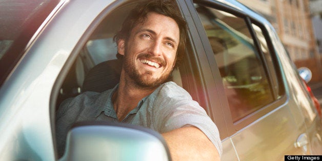 Young man looking out of car window