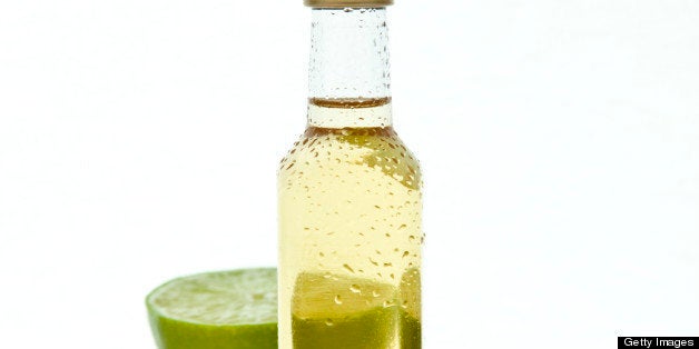 Small tequila or rum bottle with lime