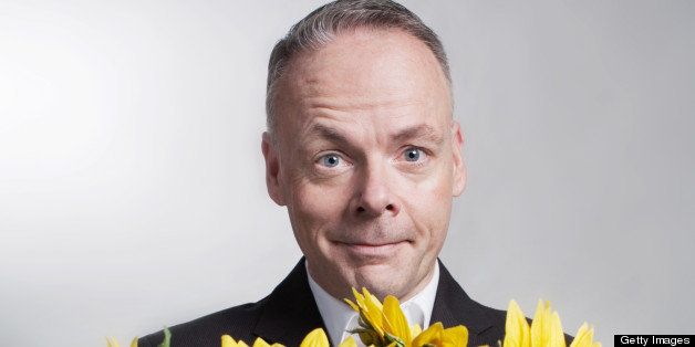 Portrait of a man with a bouquet of sunflowers