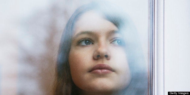 Girl looking out window