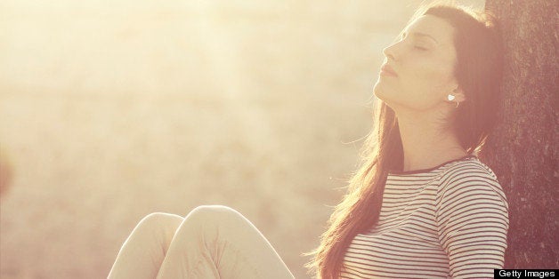 vintage colored young brunette relaxing in the summer, under the tree