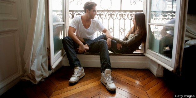 Couple sitting in windowsill