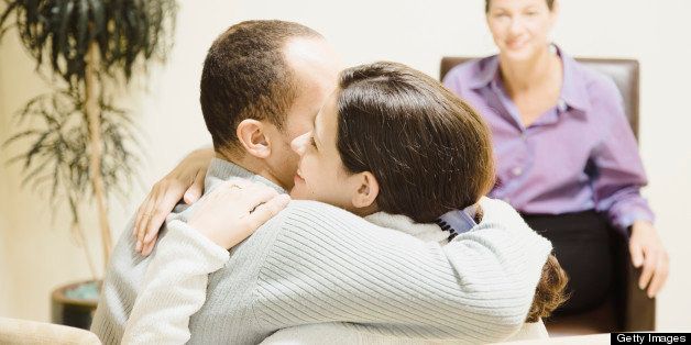 Multi-ethnic couple hugging at therapy session