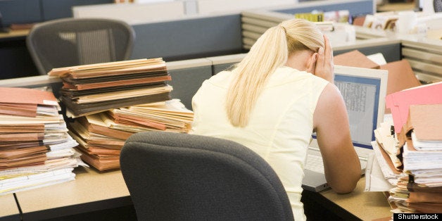 businesswoman in cubicle with...