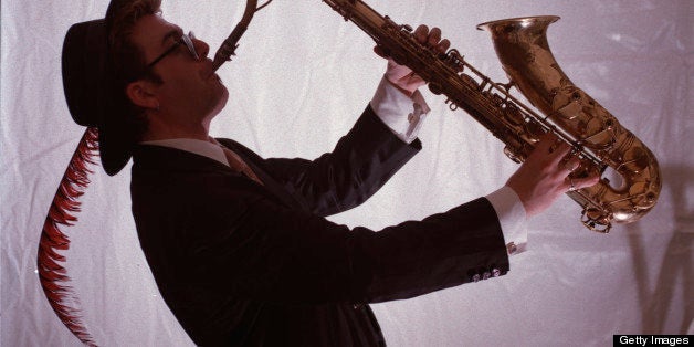 Jazz Fest pics. PIC 1 - south entrance to concert grounds on University Ave. at Queen's street. PIC 2 - Gene Hardy, tenor saxophonist for the jazz group 'Big Band Trio' from Victoria, practicing backstage. Photos by (Photo by Sean White/Toronto Star via Getty Images)