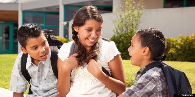Cute Hispanic Brothers and Sister Talking Ready for School on Morning.