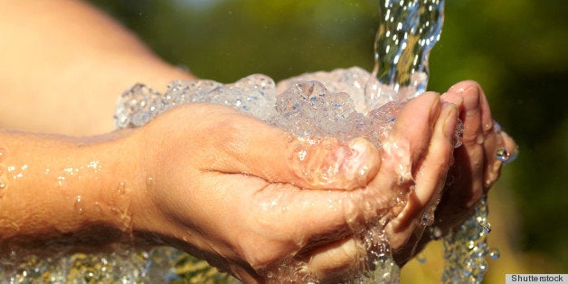 Woman's hands with water splash