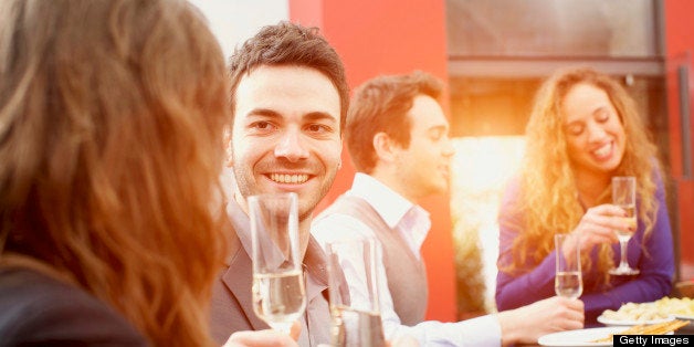 Group of friends toasting during an italian aperitif. The rays of sunset penatrate from open door.?http://www.massimomerlini.it/is/lifestyles.jpg