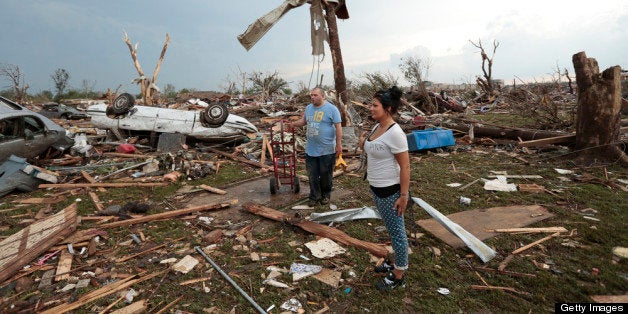 MOORE, OK- MAY 20: Philip Gotcher and his daughter Monica stand in the rubble of his house after a powerful tornado ripped through the area on May 20, 2013 in Moore, Oklahoma. The tornado, reported to be at least EF4 strength and two miles wide, touched down in the Oklahoma City area on Monday killing at least 51 people. (Photo by Brett Deering/Getty Images)