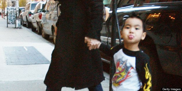 NEW YORK - DECEMBER 03: (ITALY OUT, NY DAILY NEWS OUT, NY NEWSDAY OUT) Angelina Jolie and her son Maddox, who shows his tongue to photographers, as they leave the Antique Showroom on 6th Ave after shopping December 3, 2005 in New York City. (Photo by Arnaldo Magnani/Getty Images) 