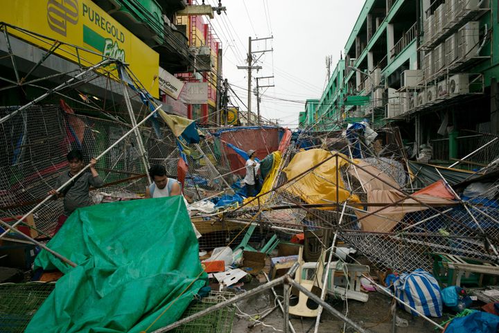 People clear the wreckage and debris of street stalls at a bazaar after Typhoon Mangkhut hit in Tuguegarao, Cagayan province, in the Philippines