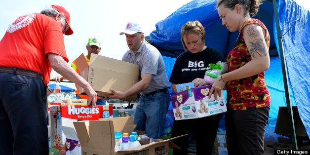 Volunteers arrange relief goods for tornado victims at a parking lot in Moore, Oklahoma, on May 24, 2013. The tornado, one of