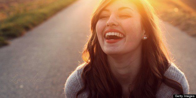 Girl in evening sun, laughing from her heart.