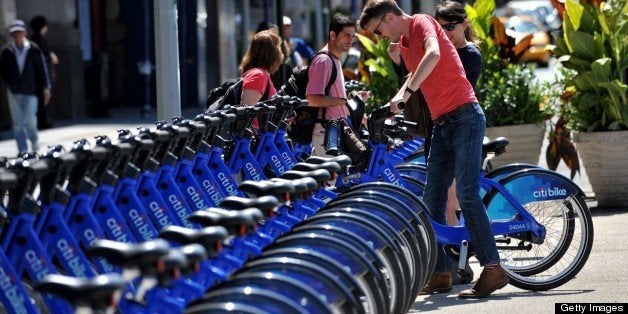With AFP Story by Brigitte DUSSEAU: US-Transport-Bicycle-Share-CitiBike A couple get their Citi Bike bicycles from a station