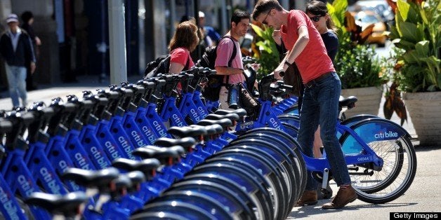 With AFP Story by Brigitte DUSSEAU: US-Transport-Bicycle-Share-CitiBike A couple get their Citi Bike bicycles from a station near Union Square as the bike sharing system is launched May 27, 2013 in New York. About 330 stations in Manhattan and Brooklyn will have thousands of bicycles for rent. AFP PHOTO/Stan HONDA (Photo credit should read STAN HONDA/AFP/Getty Images)