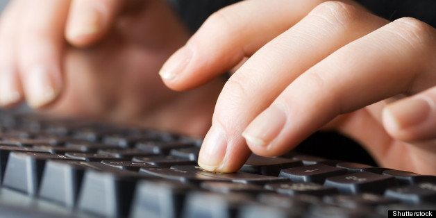 female hands typing on keyboard.