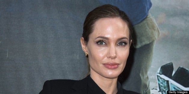 PARIS, FRANCE - JUNE 03: Angelina Jolie poses as she arrives for the Paris premiere of 'World War Z' at Cinema UGC Normandie on June 3, 2013 in Paris, France. (Photo by Pascal Le Segretain/Getty Images For Paramount)