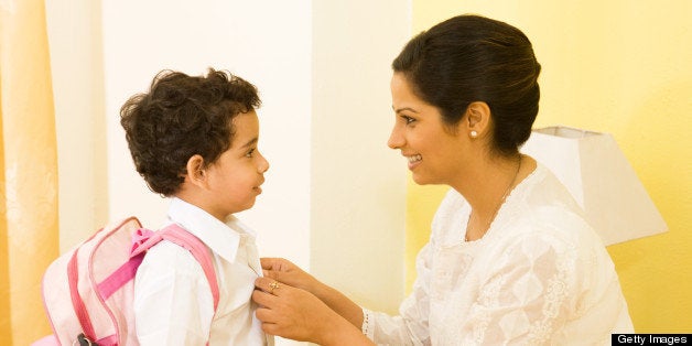 Mother helping her son to get ready for school