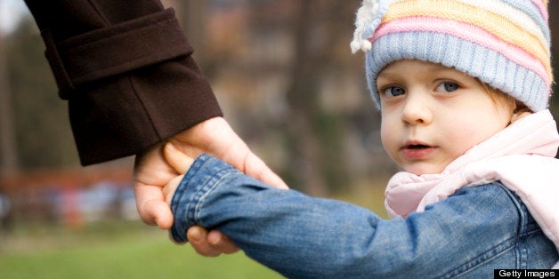 Child holding mother's hand