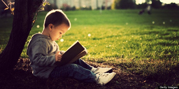 Little boy reading book.