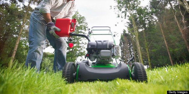 Man pouring gas into lawn mower