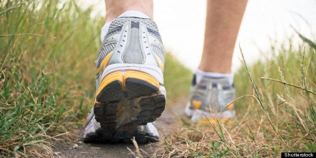 man walking on footpath sports ...