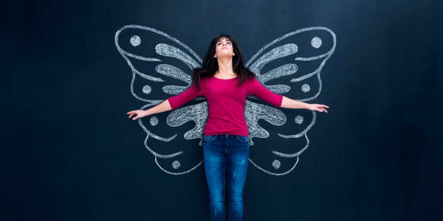 Woman flying with butterfly wings.