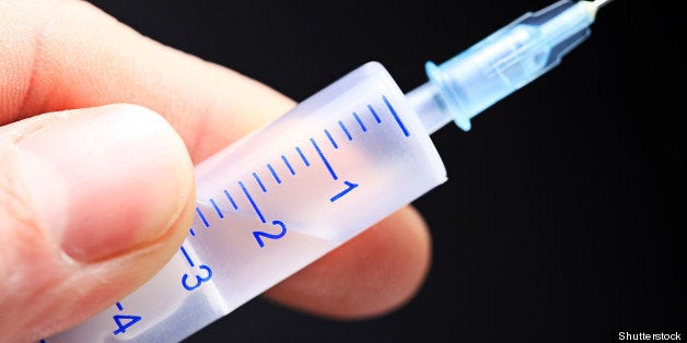 syringe in a hand. macro shot.