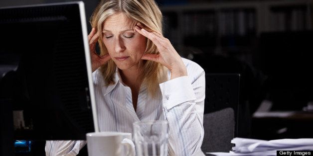 Stressed businesswoman working late