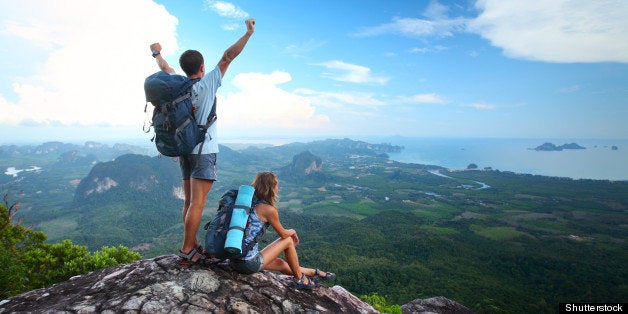 young happy backpackers on top...