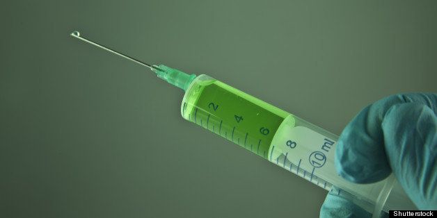 syringe in a hand ready for...