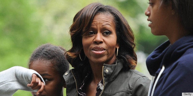 US First Lady Michelle Obama, (C) accompanied by her two daughters, Sasha (L) and Malia (R), visit Glendalough in the Wicklow Mountains National Park in Ireland, on June 18, 2013. The US First Lady visited Dublin and Glendalough in the Republic of Ireland as her husband US President Barack Obama attends the G8 Summit in Lough Erne in Northern Ireland. AFP PHOTO / ARTUR WIDAK (Photo credit should read ARTUR WIDAK/AFP/Getty Images)