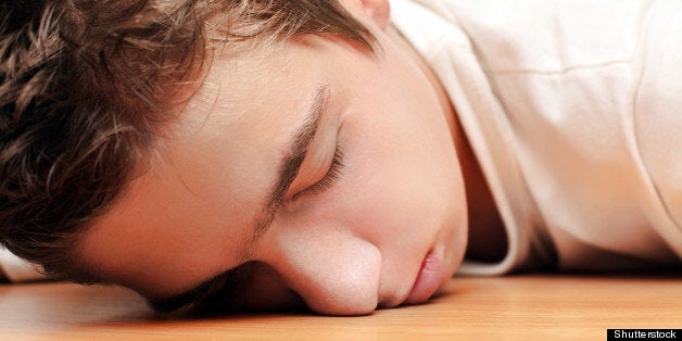 young man sleeping on the table ...