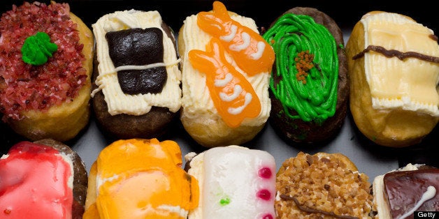 Colorful sushi donuts arranged in row.