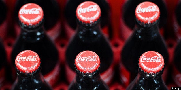 This photo taken on June 7, 2013, in Clamart, near Paris, shows newly produced Coca-Cola soft drink bottles on an assembly line at a Coca Cola bottling plant. AFP PHOTO / LIONEL BONAVENTURE (Photo credit should read LIONEL BONAVENTURE/AFP/Getty Images)