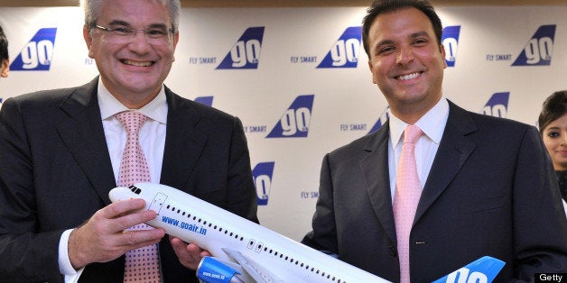 Indian budget carrier 'GoAir' CEO Giorgio Di Roni (L) and managing director Jeh Wadia pose with a model of an aircraft during a press conference in Mumbai on June 16, 2011. Wadia said his company has placed an order for 72 new A320 Airbus aircraft in a deal worth up to 6.1 billion dollars at list prices. The booming Indian market has become a key source of business for France-based Airbus, which won its biggest ever order in January from GoAir's local competitor IndiGo, who ordered 180 A320s, worth 15.6 billion dollars at list prices. AFP PHOTO/ Indranil MUKHERJEE (Photo credit should read INDRANIL MUKHERJEE/AFP/Getty Images)