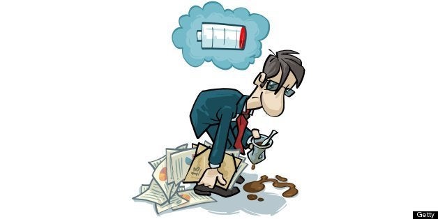 A tired office worker with an empty battery sign above his head