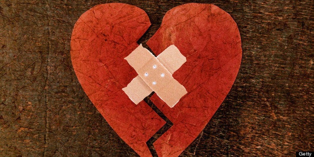 Broken heart fixed with band aid.