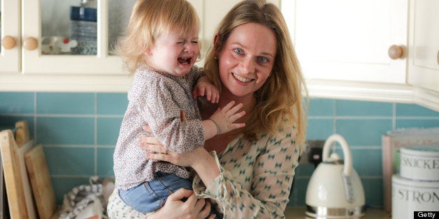 Mother holding crying daughter