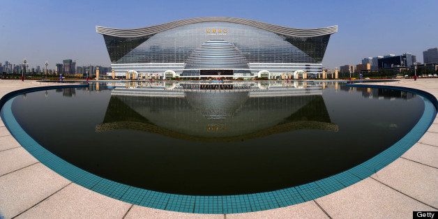 The 'New Century Global Centre' building is seen behind an artificial lake in Chengdu, in southwest China's Sichuan province on June 6, 2013. The center, claimed by Chinese officials as 'the world's largest standalone structure', is going to be opened to the public on June 28. The 100m high 'New Century Global Centre' is a symbol of the spread of China's boom: 500m long and 400m wide, with 1.7 million square metres of floor space - big enough to hold 20 Sydney Opera Houses, according to local authorities. CHINA OUT AFP PHOTO (Photo credit should read STR/AFP/Getty Images)