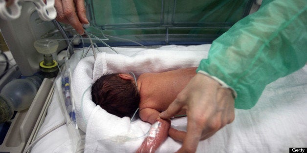 A nurse attends to a premature newborn in the neo-natal ward of the Delafontaine hospital in Saint Denis near Paris on March