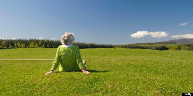 'Senior woman relaxing outdoors, on a clear summer day. Lots of copy space.'