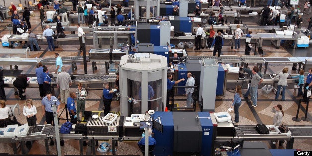 DENVER - NOVEMBER 22: Air travelers move through a main security checkpoint at the Denver International Airport on November 22, 2010 in Denver, Colorado. The TSA is bracing for heavy traffic the day before Thanksgiving, as two separate internet campaigns are promoting a 'National Opt-Out Day' protest during which travelers are urged to 'opt out' of the new body scanners because of concerns over privacy and possible exposure to radiation. Those passengers who refuse the scans must instead undergo an enhanced pat down by TSA agents, which could further slow down security lines on the busiest air travel day of the year. (Photo by John Moore/Getty Images)