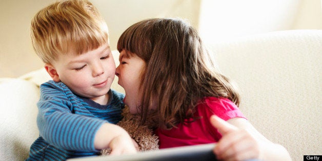 Girl using digital tablet and shouting at brother