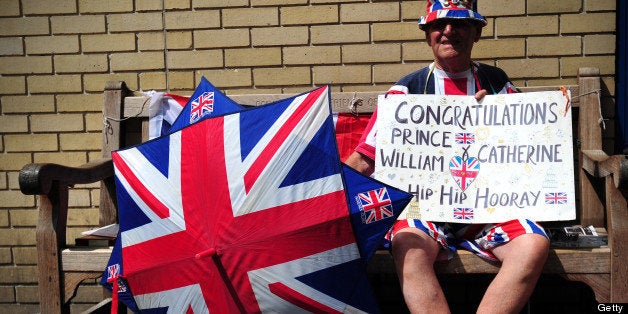 Royal well-wisher Terry Hutt poses for a picture as he waits outside the Lindo Wing of Saint Mary's Hospital in London, on July 12, 2013, where Prince William and his wife Catherine's baby will be born. Britain's royal family and the world's media are on tenterhooks awaiting the birth of Prince William and wife Catherine's first child, a baby who will one day be king or queen of Britain and a diverse group of commonwealth countries. AFP PHOTO / CARL COURT (Photo credit should read CARL COURT/AFP/Getty Images)